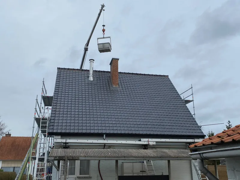 Volledig gelegd dakvlak in leikleurige pannen met nieuwe zwarte dakranden